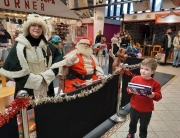 Alan Myatt handing out Christmas presents as Deluxe Father Christmas